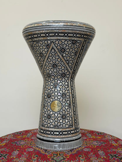Front view of The Anchor 20-inch Gawharet El Fan Dohola darbuka on a table